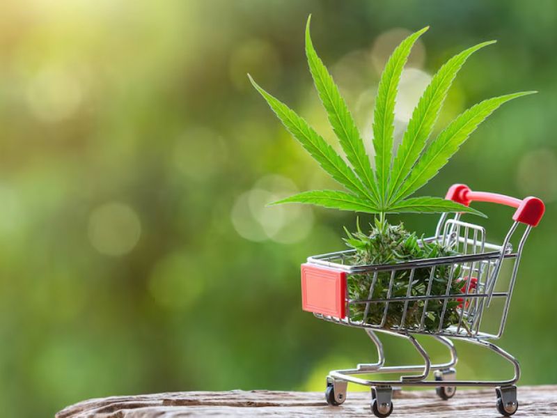 Cannabis leaves and products in a shopping cart representing dispensary product selection in Pahrump Nevada